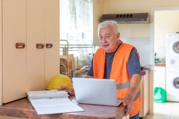 istock Small business man doing accounts at home 1306792433