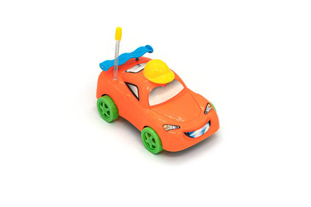 istock Plastic orange car toy isolated on white background. 1306798276