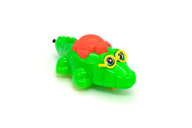 istock Children's toy, plastic crocodile isolated on white background. 1306799250