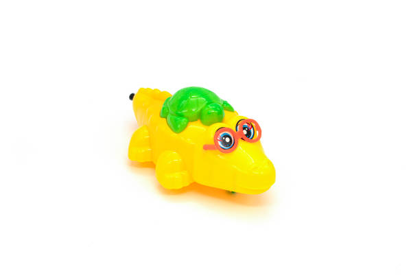 istock Children's toy, plastic crocodile isolated on white background. 1306799265