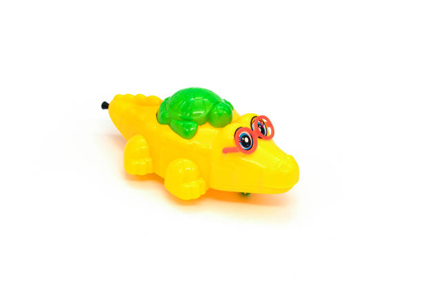 istock Children's toy, plastic crocodile isolated on white background. 1306799271