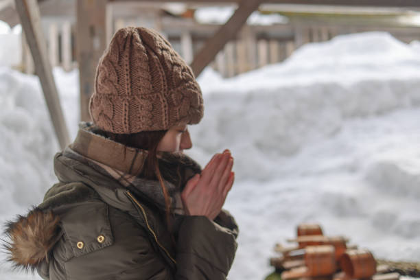 Portrait of a young adult shaman woman during an outdoor music ceremony in a winter forest