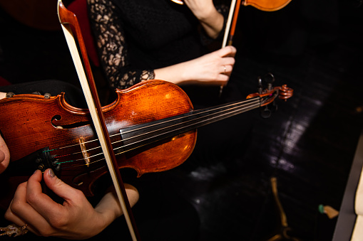 Closeup of violin in hands