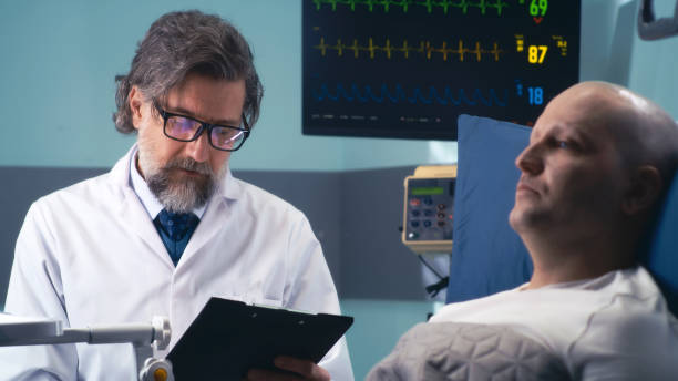 istock Mature oncologist speaking with patient in clinic 1306802598
