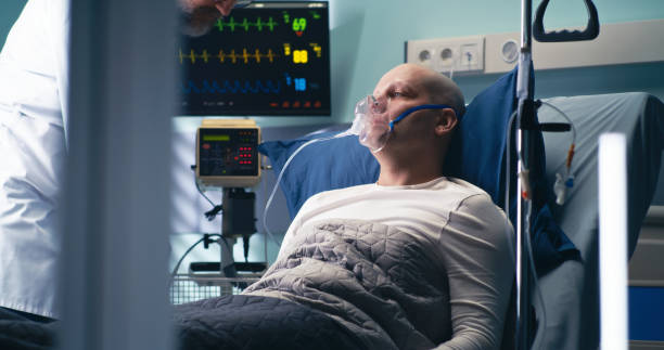 врач снабжает больного раком кислородом - real time стоковые фото и изображения