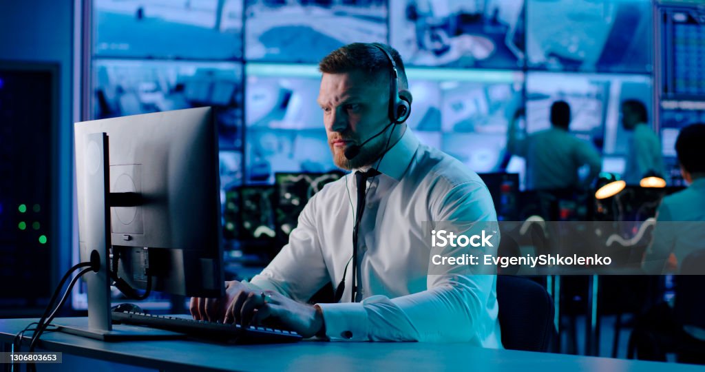 Securityman Photopc Security Agent Using Computer In Workplace Stock Photo - Download Image ...
