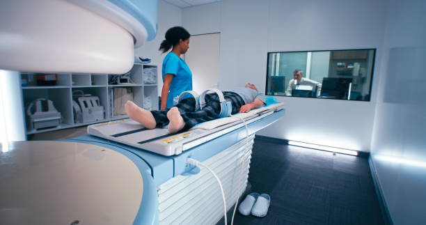 istock Diverse doctors starting MRI procedure of elderly man 1306803881