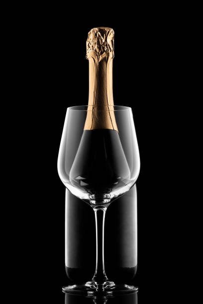 istock Champagne bottle silhouette and glass isolated on black background 1306803949