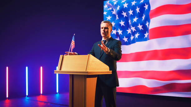 istock Presidential candidate giving speech against USA flag 1306804739