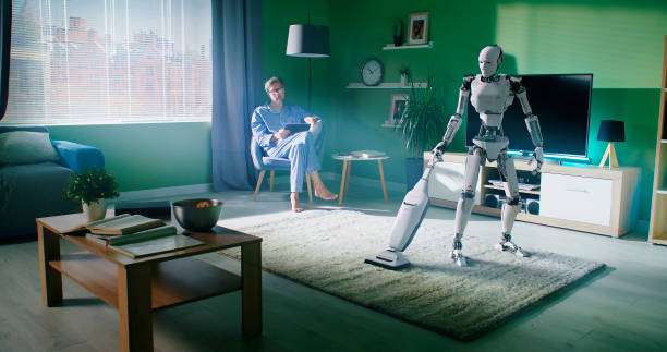 istock Humanoid cleaning carpet near owner using tablet 1306804831