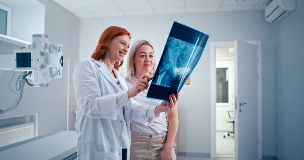 istock Doctor and patient discussing good X ray results 1306804962