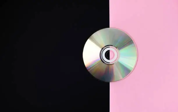 Computer-Disk on pink black background. CD and DVD background concept. Computer disk