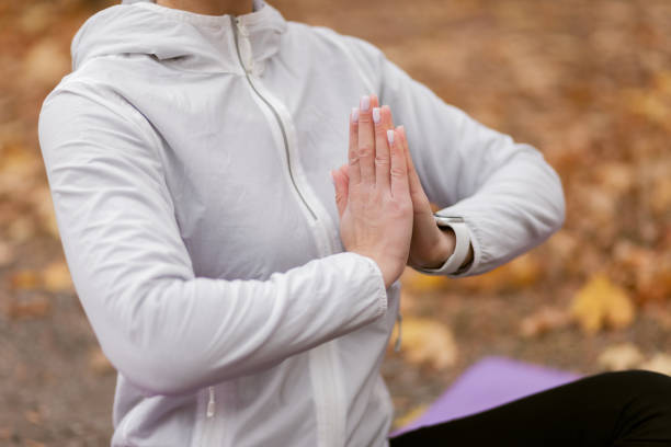 istock Young woman meditating in autumn forest 1306816650
