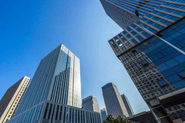 istock Modern office building against blue sky 1306816790