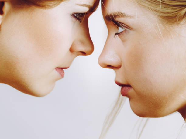 istock Two girls looking serious at each other. 1306817065
