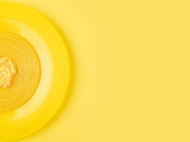 istock Linguini pasta with grated marbled cheese on a yellow plate. Monochrome 1306820187