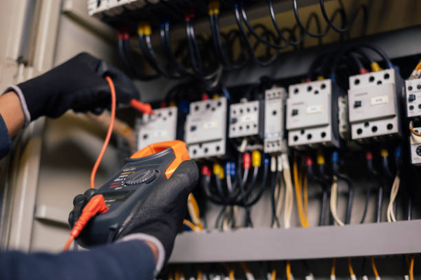 istock Electrician engineer work tester measuring voltage and current of power electric line in electical cabinet control.and wires on relay protection system. Bay control unit. Medium voltage switchgear. 1306821477