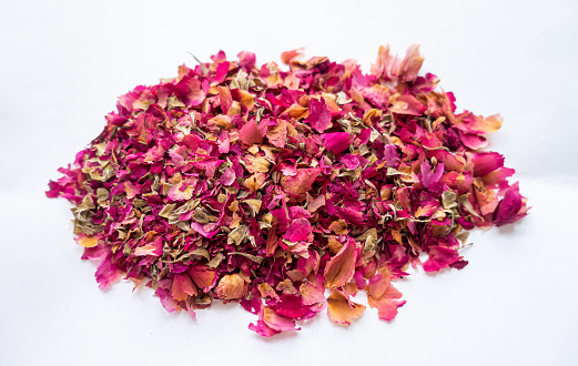 Dry rose flower petals tea on the white background