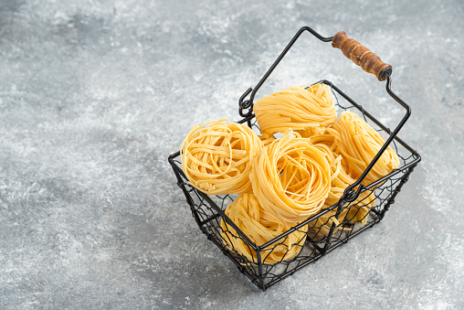 Uncooked noodle rolls in a metallic tray. High quality photo