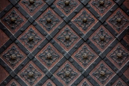 Fragment of the old wrought iron door with a pattern