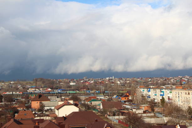 istock Dark storm clouds over a city 1306825583