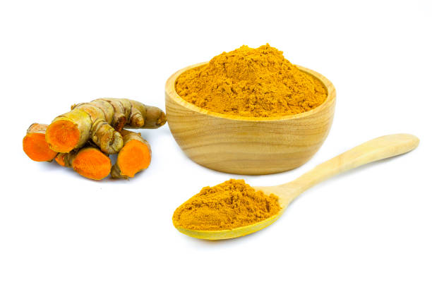 istock Turmeric (Curcuma longa Linn) rhizome (root) sliced with green leaves isolated on white background. 1306825634