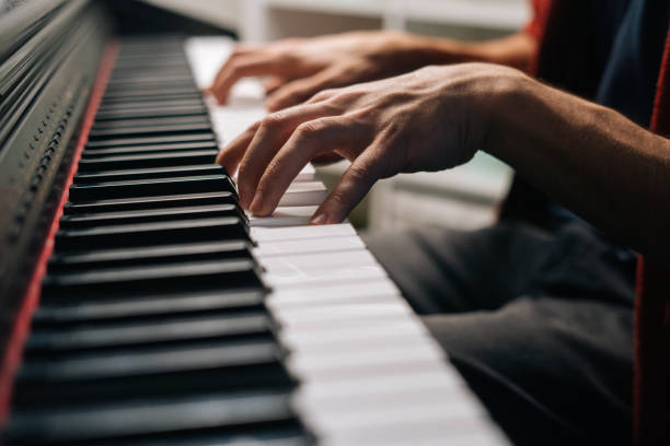 istock Close-up hands of unrecognizable musician man playing on synthesize at home studio during lesson. 1306828751