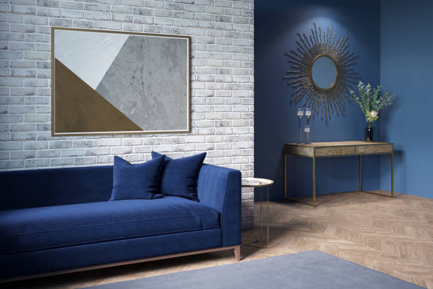 istock Modern living room with a horizontal poster on a brick wall, a dark blue sofa, a gray carpet on the parquet floor, a mirror in the background, a bouquet in a vase on a wooden sideboard. 1306828949