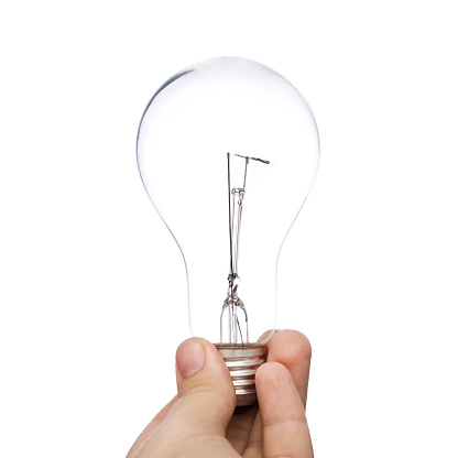 Unrecognizable male holding a light bulb isolated on white background.