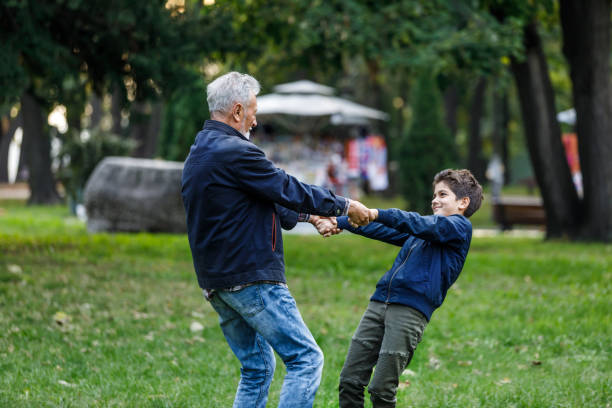 istock An Older Bearded Man is Having Fun with Grandson During an Autumn Afternoon. 1306832018