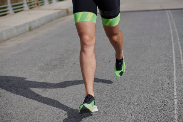 istock triathlon athlete running on street 1306836442