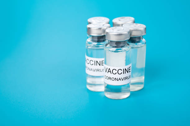 istock Covid-19 vaccine on blue medical background 1306837307