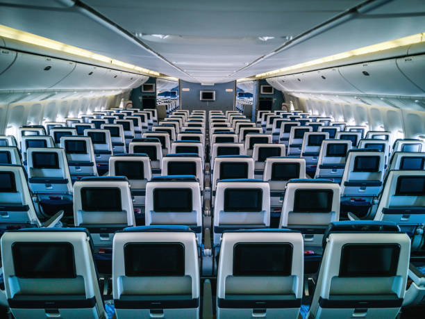 istock Modern aircraft interior with seats and blank touch entertainment 1306837702