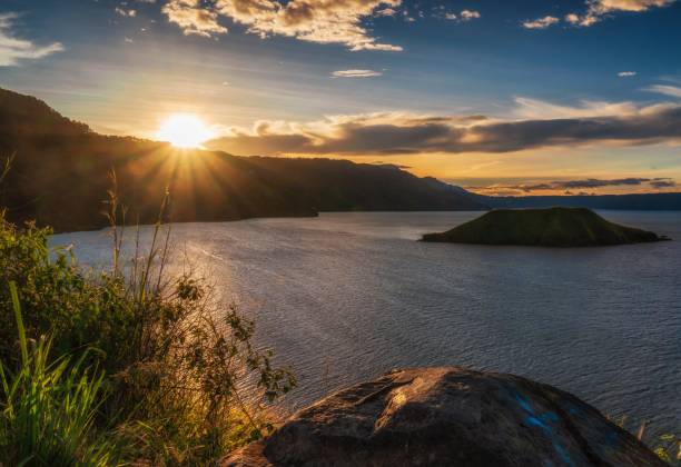 Shining This picture taken at Sipolha Hill. Located in the circle of Lake Toba. When the sun burst shining appear, shining the beauty of Lake Toba. danau toba lake stock pictures, royalty-free photos & images