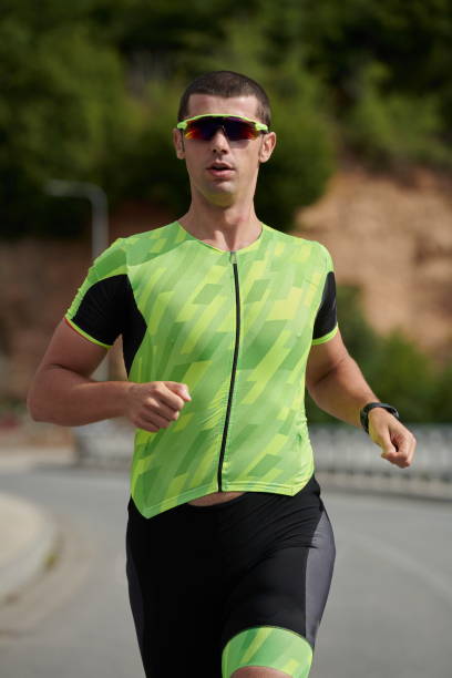 istock triathlon athlete running on street 1306838818