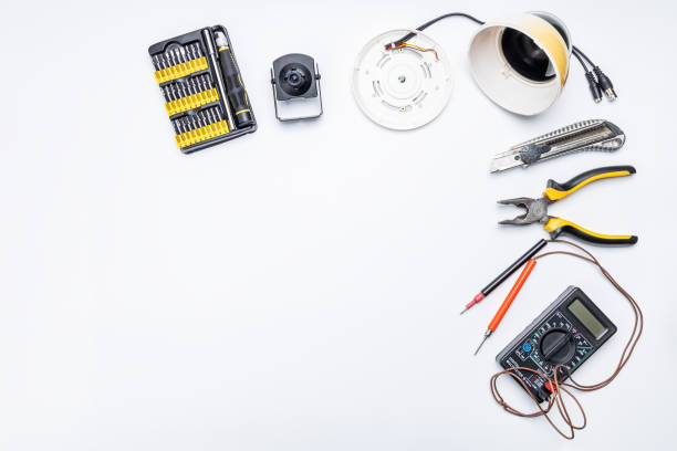 istock cctv camera service repair concept. above view. adjusting surveillance camera using tools on white desk 1306841255