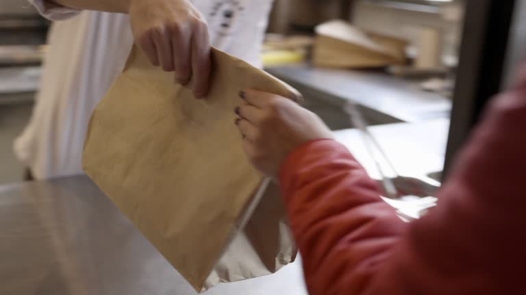 Passing take out in paper bag over the counter in the restaurant