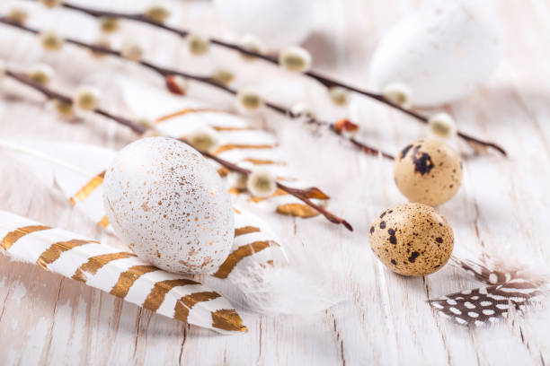 istock Easter eggs with feathers and pussy willow branch. Easter decoration. 1306843438