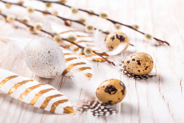 istock Easter eggs with feathers and pussy willow branch. Easter decoration. 1306843439