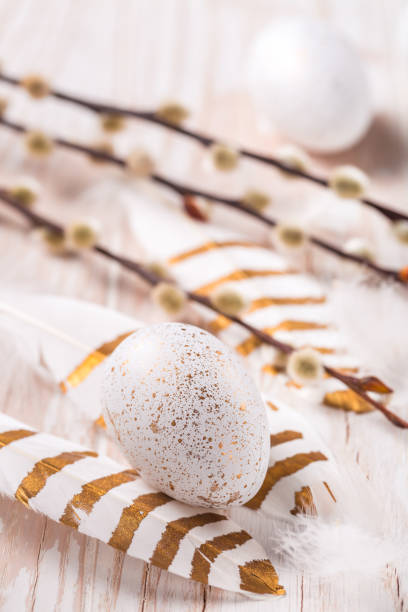 istock Easter eggs with feathers and pussy willow branch. Easter decoration. 1306843507