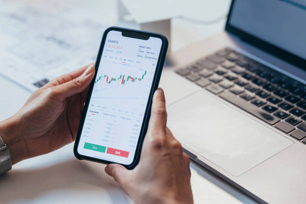 istock Anonymous Finance Expert Analyzing Financial Charts on a Smartphone 1306844400