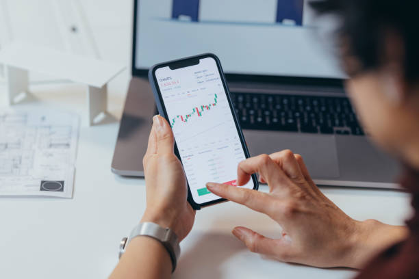 istock Anonymous Finance Expert Analyzing Financial Charts on a Smartphone 1306844405
