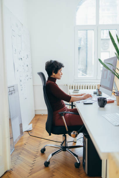 istock Side View of a Beautiful Female Designer Working on a Project in her Office 1306844430