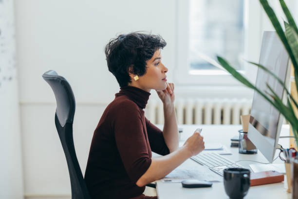 istock Side View of a Beautiful Female Designer Working on a Project in her Office 1306844432