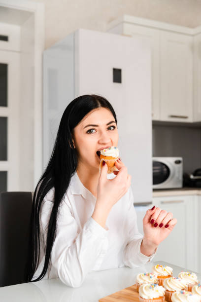 istock Young woman eat muffins 1306847166