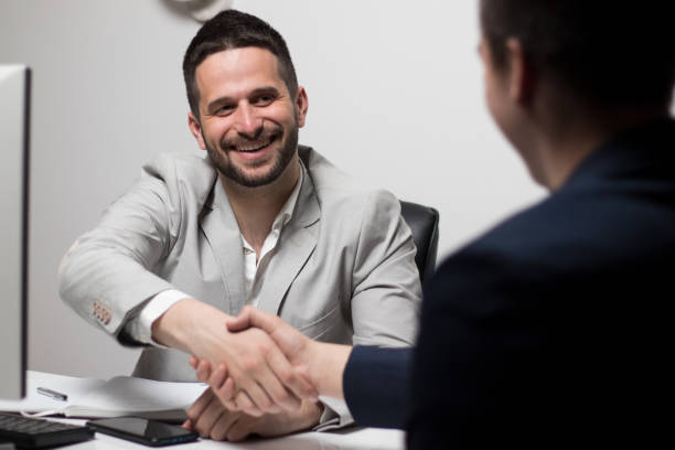 istock Two handsome young businessmen smiling and talking in office 1306849666
