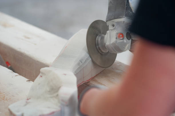 istock Close-up of Mason Using Angle Grinder to Saw Stone 1306849820