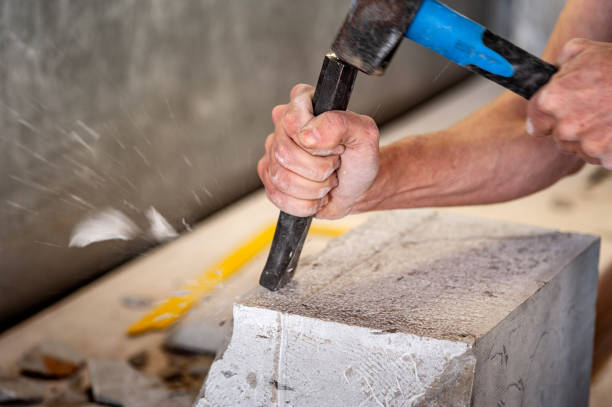 Close-up of Mason Working With Chisel and Hammer on a Piece of Marble Close-up of Mason Working With Chisel and Hammer on a Piece of Marble. stone mason stock pictures, royalty-free photos & images