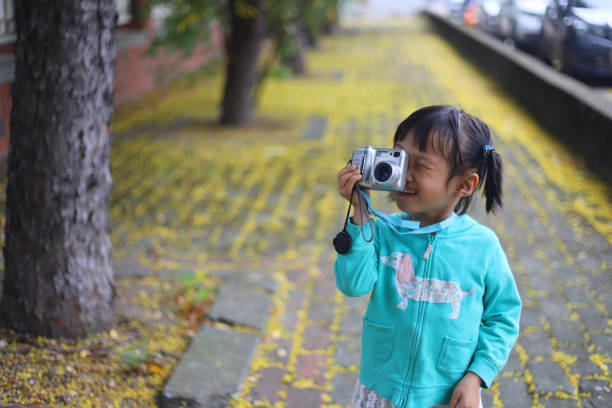 istock a girl taking photos on sidewalk 1306849845