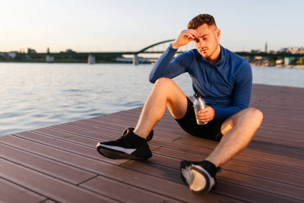 istock Exhausted young sportsman resting 1306850781